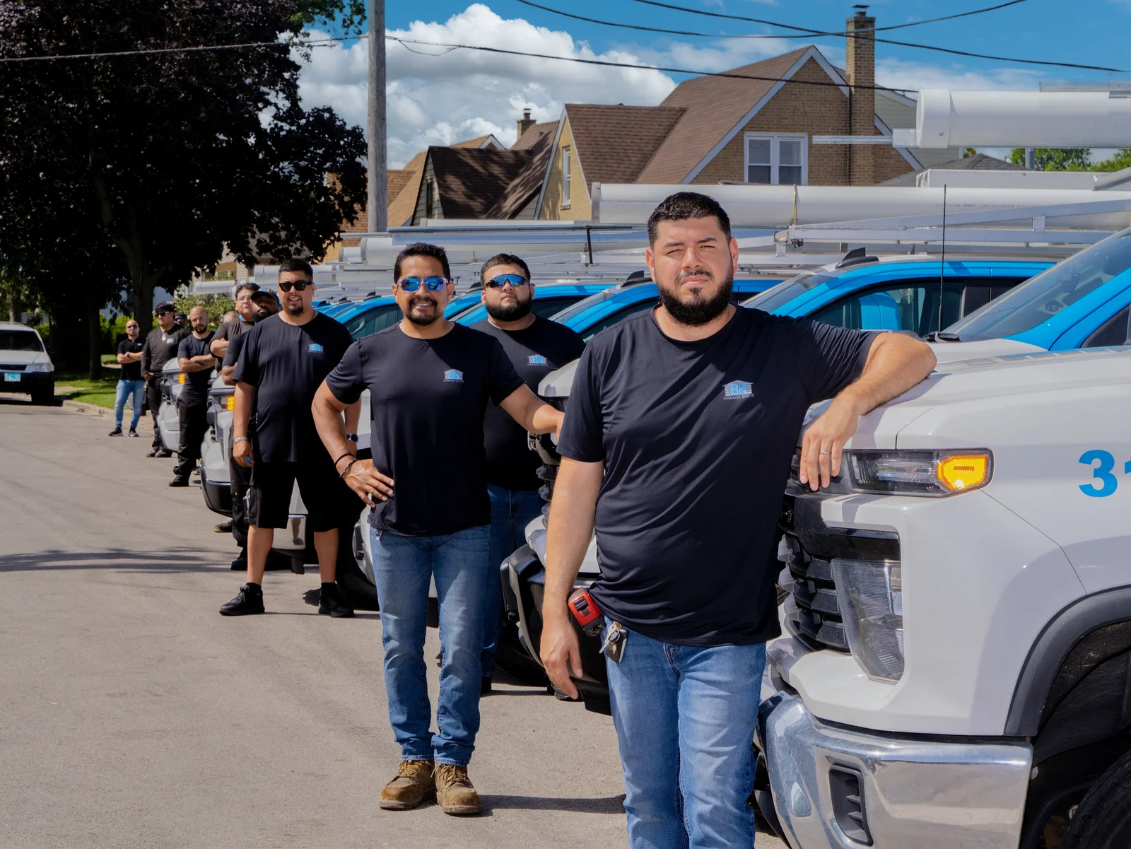 The BH Garage Door technicians lined up with the service fleet in Chicago