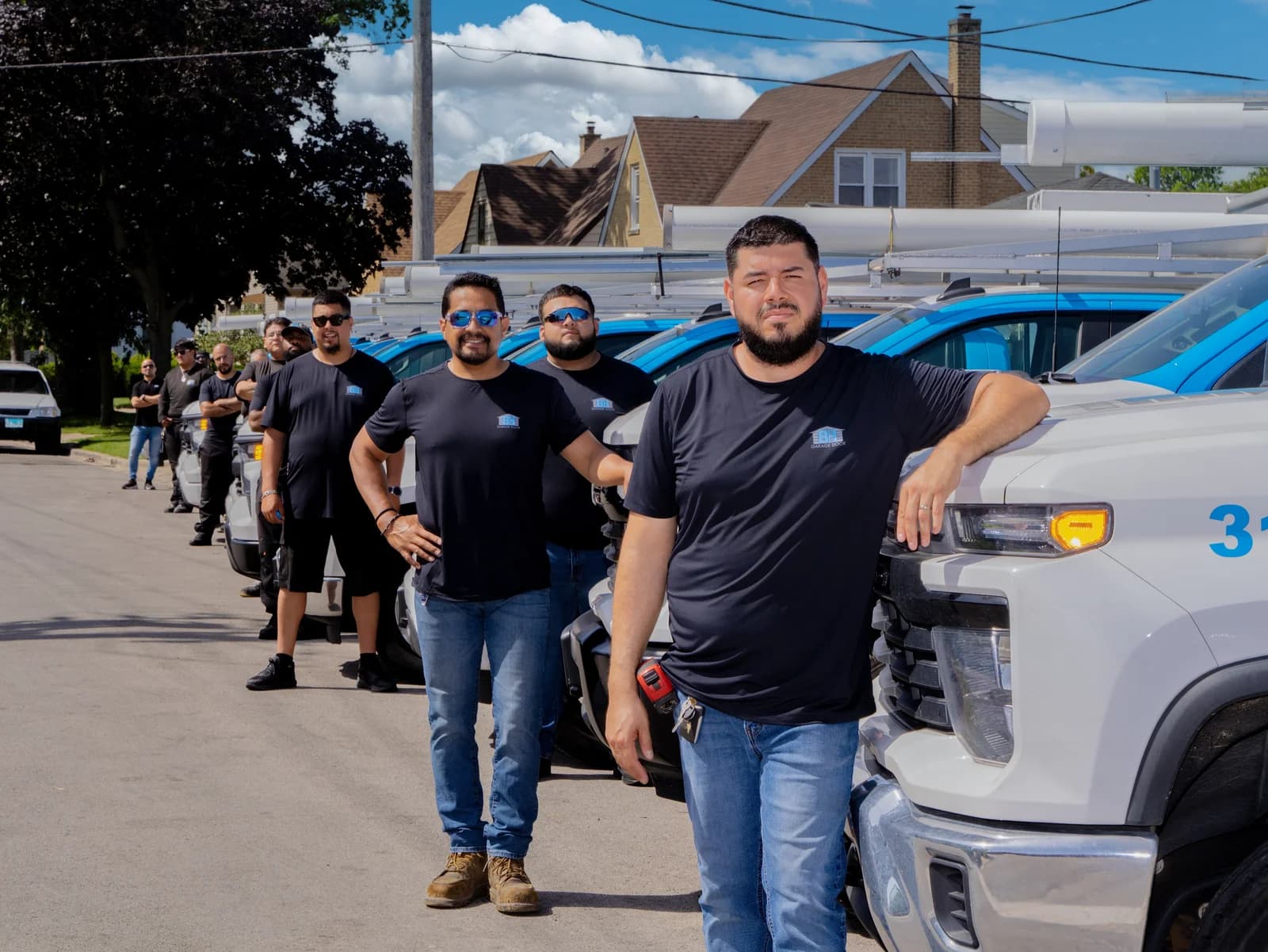 The BH Garage Door technicians lined up with the service fleet in Chicago
